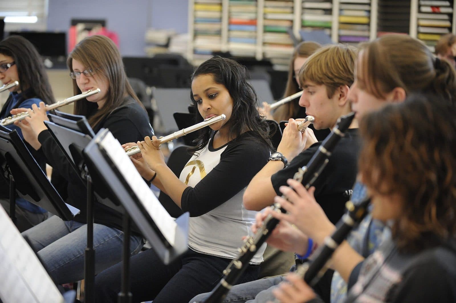 Students playing flute and clarinet in a music class