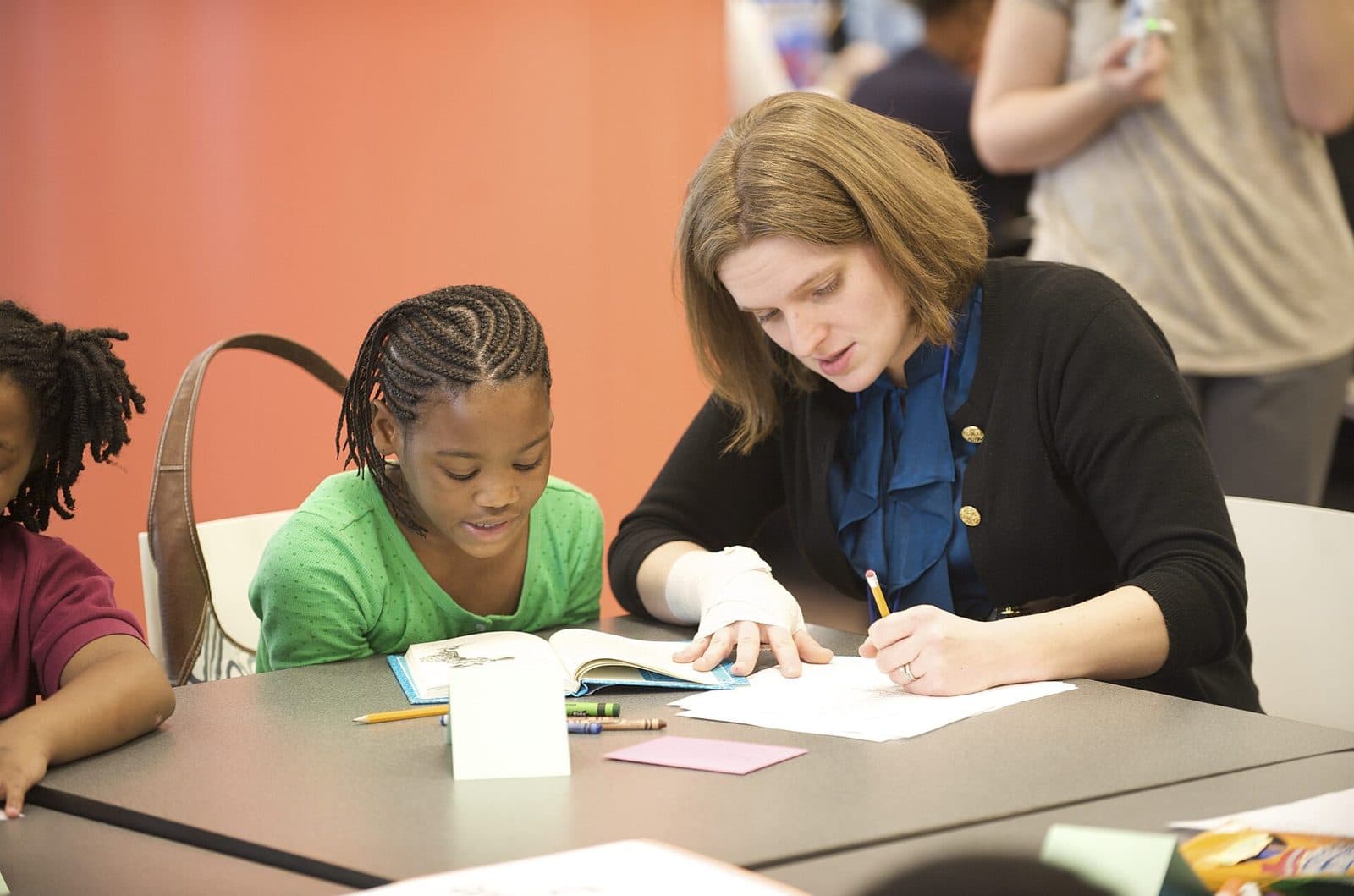 A specialist working one-on-one with a student at a table